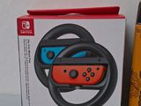 packaging of a nintendo wii game controller with a steering wheel in front of it