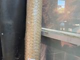 a large roll of hay sitting next to a door