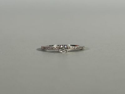 a close up of a diamond ring on a table