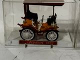 a small model of a car in a glass case