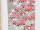 pink and white flowers on a gray background in a white frame