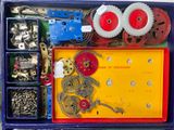 a box with a bunch of assorted gears and screws in it