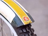 a close up of a motorcycle tire with a yellow and white stripe on it