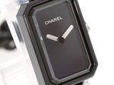 a black watch with a black face on a clear watch band