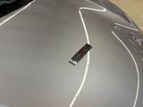 a small electronic device on the hood of a car