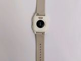 an apple watch is sitting on a white surface with a white strap