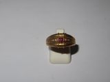 a gold ring with a red stone in it
