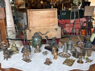 a table that has a lot of antique items on it