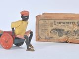 toy figurine of a man sitting on a tractor next to a box of money