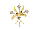 un gros plan d'une broche en forme de fleur sertie de diamants sur fond blanc
