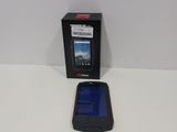 a black cell phone sitting next to a black box