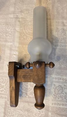 a candle that is on a wooden holder on a table