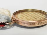 an image of a medal with a ribbon around it on a white surface