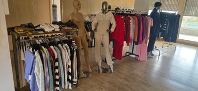 several mannequins are lined up in a clothing store