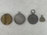 four different types of coins are shown in a row on a white surface