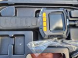 a person holding a camera in a plastic case