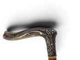 a close up of a walking stick with a wooden handle