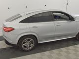 the mercedes gle is parked in a garage with a checkered floor