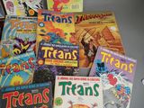 a lot of comic books that are sitting on a table