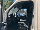 a white van with the door open and the driver ' s seat down