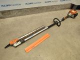 a close up of a corded hedger on the ground next to a piece of orange tape