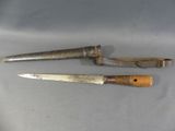 two knives are sitting next to each other on a table