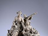 an image of a statue of a group of people sitting on top of a table