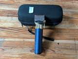 a black case with a blue handle sitting on a wooden floor