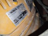 a close up of a yellow motorcycle with a sticker on it