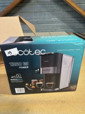 a box with a coffee maker inside of it on a table