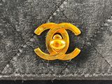 a chanel bag with a gold cc logo on it