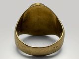 a close up of a gold ring on a white surface