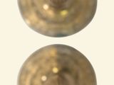 two gold vases sitting side by side on a white surface