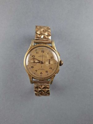 an image of a gold wrist watch on a table
