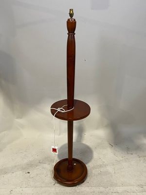 a lamp that is on a wooden stand