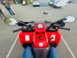 a red motorcycle that is parked in a parking lot