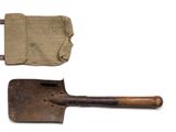 an old shovel with a canvas pouch on it and a pair of old shovels