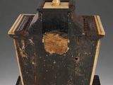 an old wooden box sitting on top of a wooden base