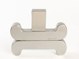 silver metal dog bone bookend on a white background