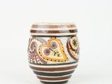 a close up of a cup on a white surface