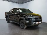 the black toyota hilux is parked in a large room