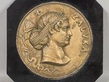 an image of a gold coin with a woman ' s head on it
