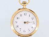 an image of a close up of a pocket watch on a white surface