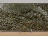 sculpture of a deer and antelope running in a forest