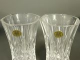 two clear glass vases sitting on a table