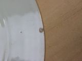 a close up of a white toilet with a wooden seat