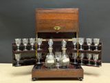 a wooden box with a set of wine glasses and a decanter