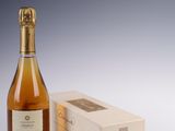 a bottle of wine next to a box of wine