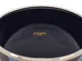 a black and blue vase with a gold rim