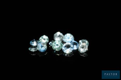 a group of blue and white diamonds sitting on top of a black surface